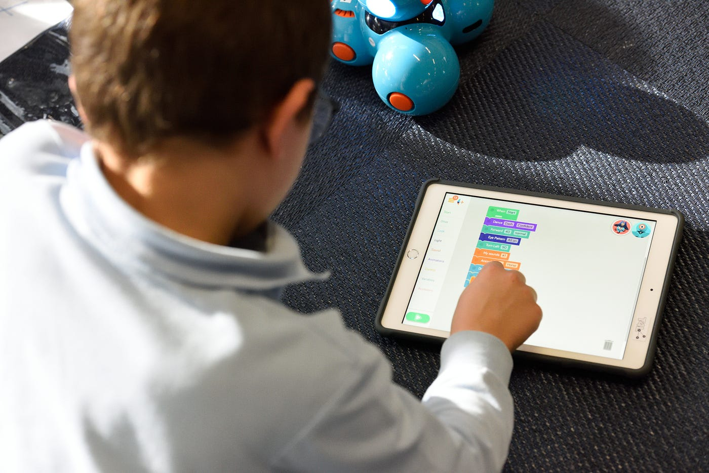 Person using tablet - Best Coding Apps for Kids