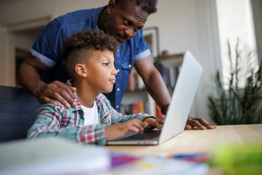 Parent teaching Laptop - Parenting Research News