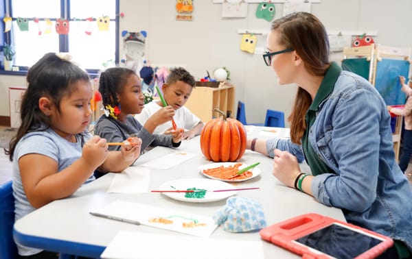 teacher in class with pumpkin - Part-Time Preschool